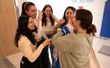 Released hostage soldier Agam Berger, right, meets Karina Ariev, Daniella Gilboa, Naama Levy, and Liri Albag, fellow soldiers also freed from Hamas captivity, at Rabin Medical Center, January 30, 2025. (Israel Defense Forces)