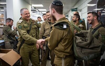 Maj. Gen. David Zini, the head of the IDF's Training Command (left), greets an ultra-Orthodox soldier drafting to the IDF's new Haredi brigade, known as the Hasmonean Brigade, January 5, 2025. (Israel Defense Forces)