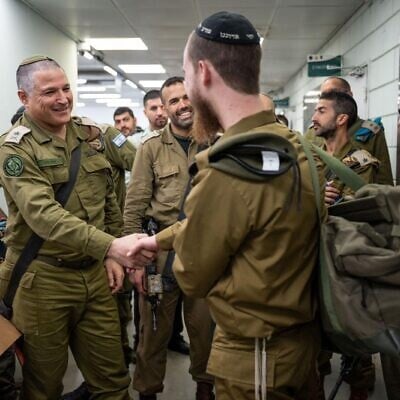 Maj. Gen. David Zini, the head of the IDF's Training Command (left), greets an ultra-Orthodox soldier drafting to the IDF's new Haredi brigade, known as the Hasmonean Brigade, January 5, 2025. (Israel Defense Forces)