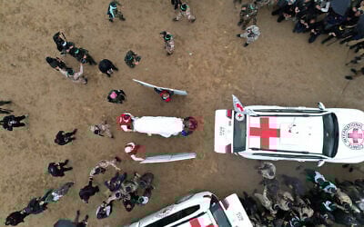 Red Cross representatives receive from Hamas terrorists coffins apparently containing the bodies of four slain Israeli hostages, in Khan Younis, southern Gaza Strip, February 20, 2025. (Reuters/Stringer)