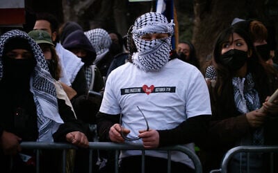 A man wearing a shirt celebrating the October 7, 2023, invasion of Israel at funeral rally for Hezbollah terror chief Hassan Nasrallah, in New York City, February 23, 2025. (Luke Tress/Times of Israel)