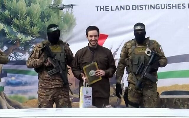 Omer Shem Tov, flanked by armed Hamas fighters, is freed in a Hamas propaganda ceremony in Nuseirat in central Gaza on February 22, 2025 (Screen grab/YouTube)