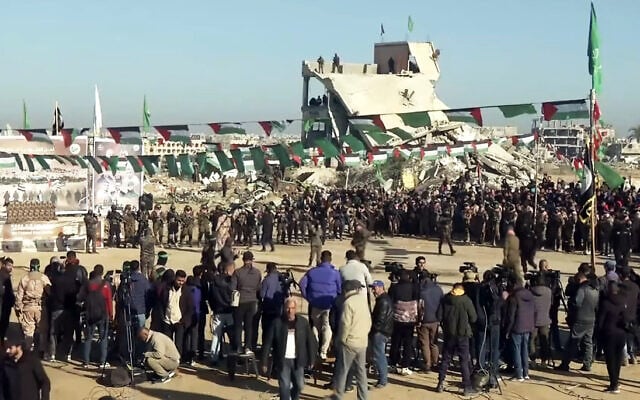 Hamas gunmen secure an area before handing over Israeli hostages to a Red Cross team in Khan Yunis in the southern Gaza Strip on February 15, 2025 (Screen grab/YouTube)