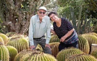 Oded (right) and Yocheved Lifshitz, in a cactus garden they planted outside their home, before October 7, 2023 (Amiram Oren)