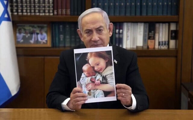 Prime Minister Benjamin Netanyahu holds up a photo of Ariel and Kfir Bibas in a video message, February 21, 2025. (Screenshot/GPO) Prime Minister Benjamin Netanyahu holds up a photo of Ariel and Kfir Bibas in a video message, February 21, 2025. (Screenshot/GPO)