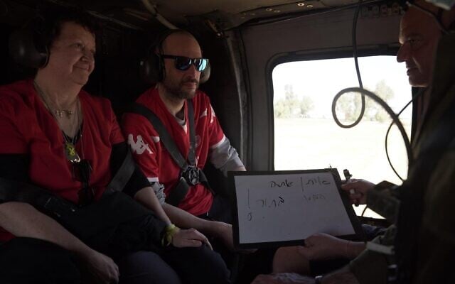 Released hostage Iair Horn (right) holds up a whiteboard, saying, 'Eitan, you're next!' Iair's brother Eitan is still held hostage in Gaza (IDF)