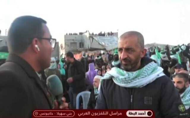 Freed Hamas terrorist Mohammad Abu Warda (right) seen in a TV broadcast from the handover ceremony of slain Israeli hostages in Khan Younis, February 20, 2025. (Screenshot from X, used in accordance with Clause 27a of the Copyright Law) Freed Hamas terrorist Mohammad Abu Warda (right) seen in a TV broadcast from the handover ceremony of slain Israeli hostages in Khan Younis, February 20, 2025. (Screenshot from X, used in accordance with Clause 27a of the Copyright Law)