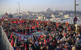 Demonstrators hold a banner and Palestinian and Turkish flags as they attend a pro-Palestinian, anti-Israel rally at the Galata Bridge in Istanbul on January 1, 2025, amid the continuing war between Israel and the Hamas terror group. (Yasin Akgul / AFP)