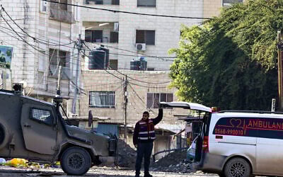 FILE: A Palestinian paramedic opens the back of an ambulance, as ordered by Israeli troops at a roadblock, during a military raid in Jenin, West Bank, on January 29, 2025. (Zain JAAFAR / AFP)