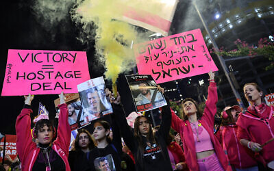 Demonstrators raise placards during a protest calling for the release of hostages held captive in Gaza, in front of the Defense Ministry in Tel Aviv on February 1, 2025. (Jack GUEZ / AFP)