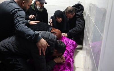 Relatives bid farewell to a Palestinian man, killed during an Israeli military raid in Jenin in the West Bank, after Israel gave permission for bodies kept at a hospital morgue to be buried, on February 2, 2025. (JAAFAR ASHTIYEH / AFP)