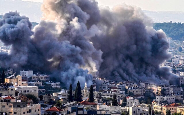 Smoke billows from the site of several explosions during an Israeli raid on Jenin in the northern West Bank, February 2, 2025. (Mohammad Mansour / AFP)