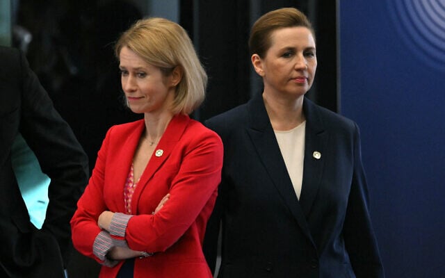Denmark's Prime Minister Mette Frederiksen (R) walks past Vice-President of the European Commission Kaja Kallas at the start of an informal EU leaders' retreat at the Palais d’Egmont in Brussels on February 3, 2025. (Photo by NICOLAS TUCAT / AFP)