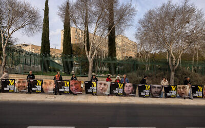 Supporters and relatives of Israeli hostages hold posters with pictures of captives reading "Don't leave me behind," in front of the prime minister's office in Jerusalem on February 3, 2025. (Menahem Kahana / AFP)