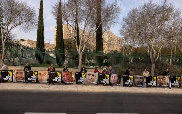 Supporters and relatives of Israeli hostages hold posters with pictures of captives reading "Don't leave me behind," in front of the prime minister's office in Jerusalem on February 3, 2025. (Menahem Kahana / AFP) Supporters and relatives of Israeli hostages hold posters with pictures of captives reading "Don't leave me behind," in front of the prime minister's office in Jerusalem on February 3, 2025. (Menahem Kahana / AFP)