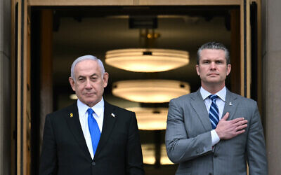 US Secretary of Defense Pete Hegseth (R) places his hand on his heart as he welcomes Israeli Prime Minister Benjamin Netanyahu to the Pentagon in Arlington, Virginia, on February 5, 2025. (Jim WATSON / AFP)