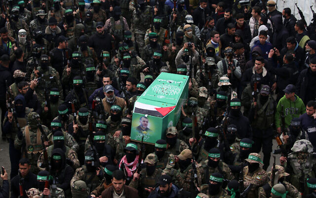 Hamas operatives carry the coffin of Marwan Issa, a top Hamas commander killed in March 2024, during his funeral procession in the war-devastated Bureij camp in the central Gaza Strip on February 7, 2025. (Eyad BABA / AFP)