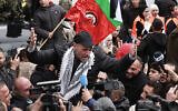 A former Palestinian prisoner released by Israel is cheered by a crowd after stepping out of a bus in the West Bank city of Ramallah on February 8, 2025.(Jaafar Ashtiyeh/AFP)