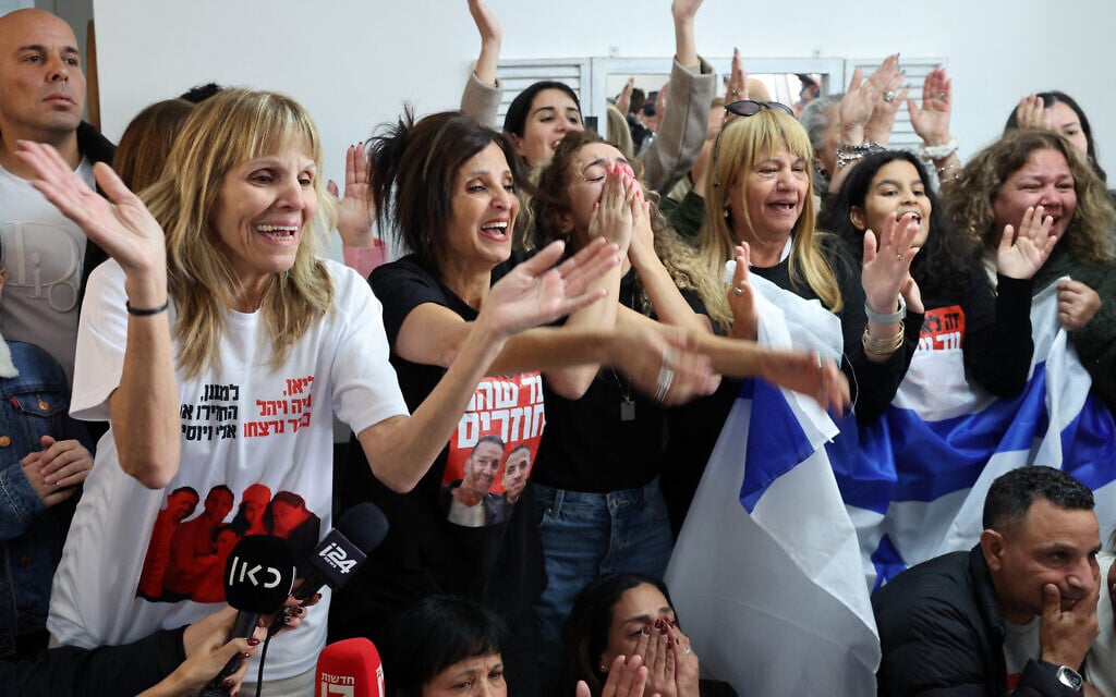 Close relatives of Israeli hostage Eli Sharabi cheer as they watch on a television screen his release along with two other hostages from Hamas captivity in the Gaza Strip, at the family home in Tel Aviv on February 8, 2025.(Photo by Jack GUEZ / AFP)