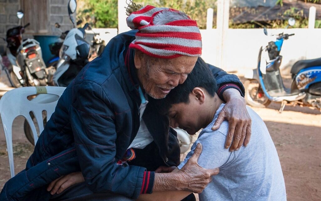 Freed Thai farm worker Watchara Sriaoun (R) hugs his grandfather Sompong Sriaoun (L) upon return to his hometown in Thailand's northeast Udon Thani province on February 9, 2025, following his release by terrorists in Gaza (Chanakarn Laosarakham / AFP)