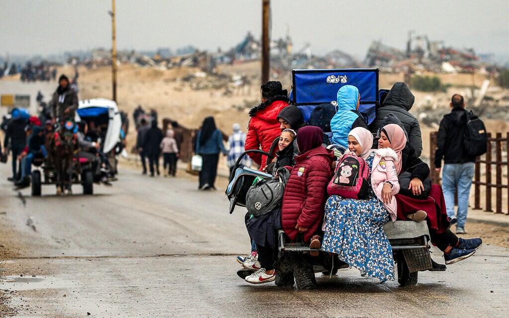 Men and children ride in the back of a tricycle cart along the Wadi Gaza bridge along al-Rashid street across between Gaza City and Nuseirat in the central Gaza Strip on February 10, 2025. (Eyad Baba/AFP)
