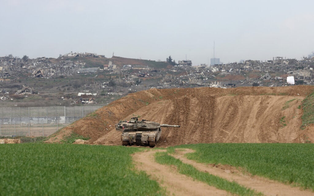 A picture taken from the Israeli side of the border with the Gaza Strip shows an Israeli army tank stationed on a hill overlooking northern Gaza on February 12, 2025. (Menahem KAHANA / AFP)