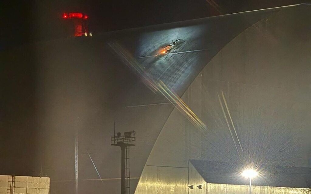A handout image taken from the X account of the International Atomic Energy Agency (IAEA) on February 14, 2025 shows a glow after a UAV apparently struck the roof at the New Safe Confinement (NSC), which protects the remains of reactor 4 of the former Chornobyl Nuclear Power Plant, causing a fire. (International Atomic Energy Agency (IAEA) / AFP)