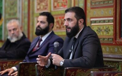 Syria's de facto leader Ahmed al-Sharaa attends a meeting with officials and local leaders in the western coastal city of Tartus, Syria, in a handout photo issued on February 16, 2025. (Syrian Presidency / AFP)