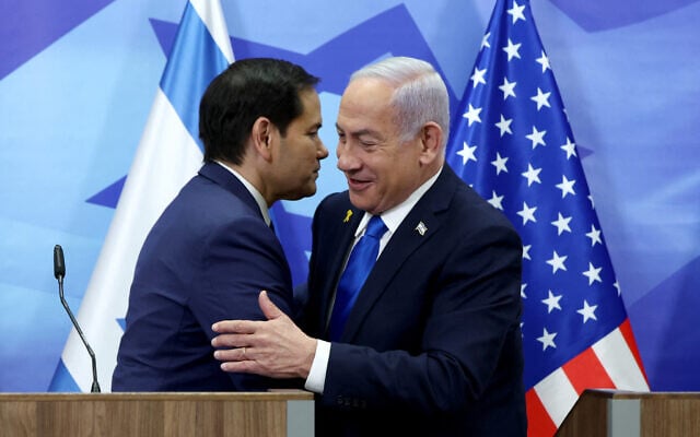 US Secretary of State Marco Rubio (L) and Prime Minister Benjamin Netanyahu greet each other before making a joint statement to the media at the Prime Minister's office in Jerusalem on February 16, 2025 (Evelyn Hockstein / AFP)