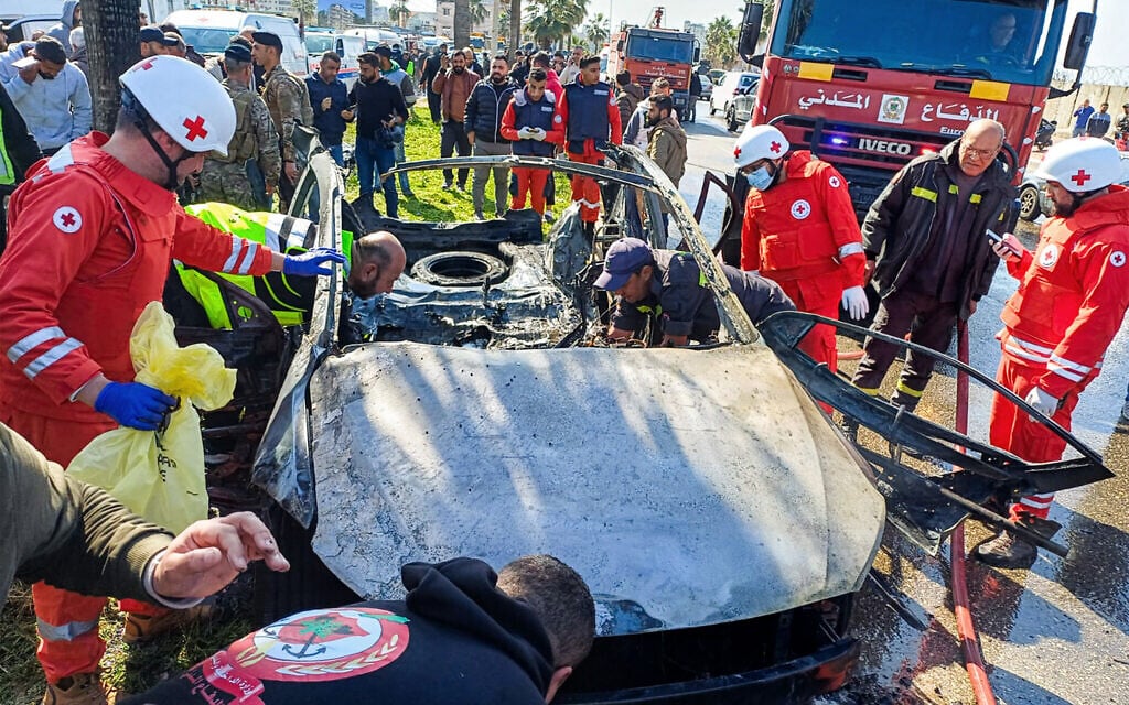 Lebanese army, security forces, and civil defense first responders inspect the remains of a destroyed vehicle that was reportedly hit by an Israeli strike in Lebanon's southern city of Sidon on February 17, 2025. (Photo by AFP)
