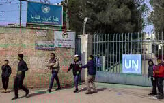 Children gather outside the gate of the Kalandia Training Centre, run by the United Nations Relief and Works Agency for Palestine Refugees, which was raided by Israeli forces earlier in the day on February 18, 2025. (Zain Jaafar / AFP)