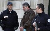 French policemen escort Georges Ibrahim Abdallah (C), a Lebanese terrorist sentenced to life in prison for the murder of two diplomats, one American and the other Israeli, as Abdallah leaves Pau's Courthouse, southwestern France, on February 18, 2010. (Jean-Louis Duzert / AFP)