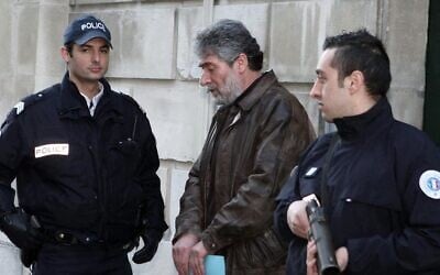 French policemen escort Georges Ibrahim Abdallah (C), a Lebanese terrorist sentenced to life in prison for the murder of two diplomats, one American and the other Israeli, as Abdallah leaves Pau's Courthouse, southwestern France, on February 18, 2010. (Jean-Louis Duzert / AFP)