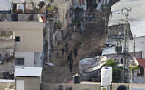 Israeli soldiers walk during a counter-terror raid in the Tulkarem camp in the West Bank on February 18, 2025 (Jaafar ASHTIYEH / AFP)