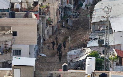 Israeli soldiers walk during a counter-terror raid in the Tulkarem camp in the West Bank on February 18, 2025 (Jaafar ASHTIYEH / AFP)