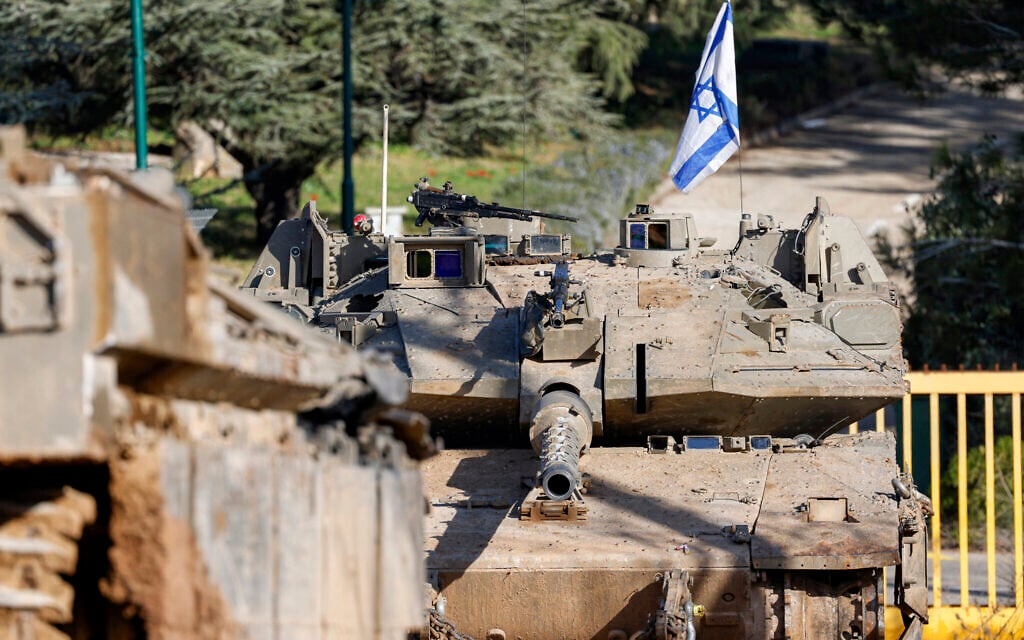 An Israeli army Merkava main battle tank is deployed by the concrete border wall at a position along Israel's northern border with Lebanon on February 18, 2025. (Photo by Jalaa MAREY / AFP)
