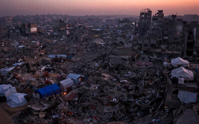 Tents belonging to Palestinians are seen amid the rubble of destroyed buildings in Jabalia, in the northern Gaza Strip, on February 18, 2025, as people return to northern parts of Gaza during a ceasefire deal in the war between Israel and Hamas. (Photo by Omar AL-QATTAA / AFP)