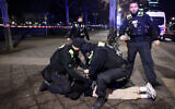 Police apprehend a suspect at the scene where a person was stabbed near the Holocaust Memorial in Berlin, Germany on February 21, 2025. (Odd Andersen/AFP)
