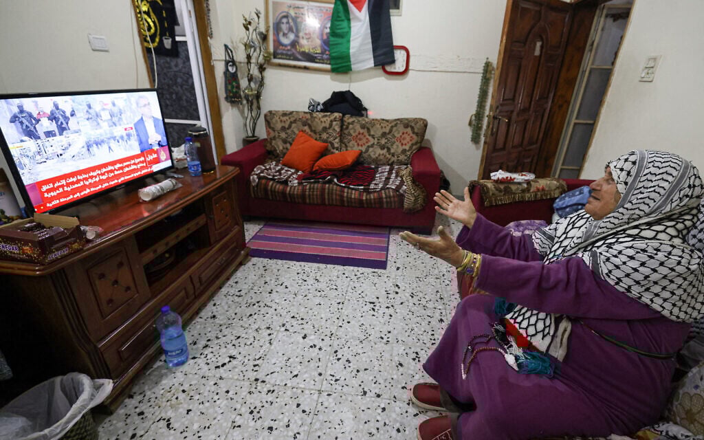 The mother of Palestinian prisoner Khaled Khdeish, who was set to be released alongside hundreds of Palestinian prisoners on Saturday, watches the news awaiting information on his release at her home in the Balata camp, east of Nablus in the West Bank on February 22, 2025. (Jaafar ASHTIYEH/AFP)