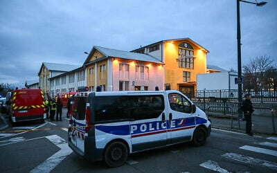 This photograph shows firefighter (L) and police vehicles near the site of a bladed weapon attack where a man is suspected of killing one person and wounding two municipal police officers in Mulhouse, eastern France on February 22, 2025. (Sebastien Bozon/AFP)