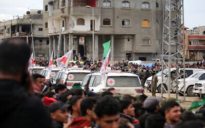 International Red Cross (ICRC) vehicles arrive at the scene shortly before Hamas fighters release of three Israeli hostages as part of the seventh hostage-prisoner swap, in Nuseirat in the central Gaza Strip on February 22, 2025. (Eyad Baba/AFP)