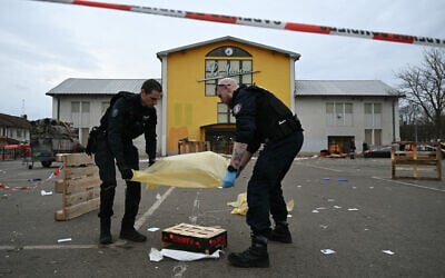 French municipal police officers work to collect evidence at the site of a bladed weapon attack where a man is suspected of killing one person and wounding two municipal police officers in Mulhouse, eastern France on February 22, 2025. (Sebastien Bozon/AFP)