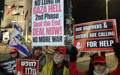 Demonstrators raise placards and chant slogans during a protest calling for the release of hostages held captive in Gaza since the October 7, 2023, attack by Palestinian terrorists, in front of the Israeli Defense Ministry in Tel Aviv on February 22, 2025. (Jack Guez / AFP)