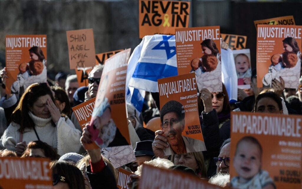 Protestors hold placards reading 'unforgivable,' 'unjustifiable' and 'unnameable' as they gather in front of the Shoah Memorial to pay tribute to the hostages whose bodies were returned to Israel by Hamas, at an event held by the Representative Council of Jewish Institutions in France (CRIF) in central Lyon, southeastern France, on February 23, 2025. (JEAN-PHILIPPE KSIAZEK / AFP)