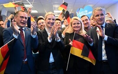 Germany's far-right Alternative for Germany (AfD) party candidate for chancellor Alice Weidel, second from left, and other top party officials applaud after German television publishes the first exit polls in the German general elections, during the electoral evening in Berlin, Germany, February 23, 2025. (Soeren Stache / Pool / AFP)