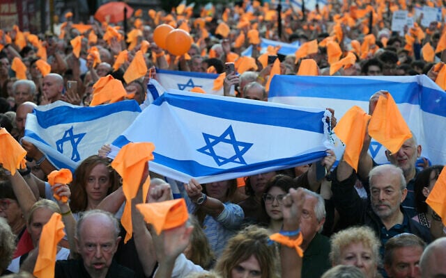 People wave orange handkerchiefs in honor of the Bibas children as they demonstrate for the release of all remaining hostages held in Gaza since Hamas's October 7, 2023, onslaught on Israel, in Buenos Aires on February 24, 2025. (JUAN MABROMATA / AFP) People wave orange handkerchiefs in honor of the Bibas children as they demonstrate for the release of all remaining hostages held in Gaza since Hamas's October 7, 2023, onslaught on Israel, in Buenos Aires on February 24, 2025. (JUAN MABROMATA / AFP)