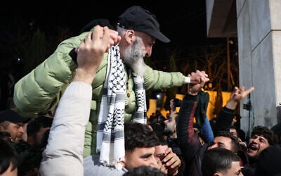 A former Palestinian prisoner, released as part of the seventh hostage-prisoner exchange, is carried on a person's shoulders upon arrival in Ramallah on February 27, 2025. (Zain Jaafar/AFP)