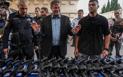 National Security Minister Itamar Ben-Gvir attends an event to deliver weapons to local volunteer security group members in Ashkelon, October 27, 2023. (AP/Tsafrir Abayov) National Security Minister Itamar Ben-Gvir attends an event to deliver weapons to local volunteer security group members in Ashkelon, October 27, 2023. (AP/Tsafrir Abayov)