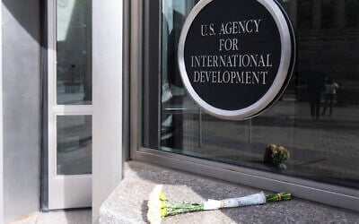 A bouquet of white flowers placed outside the headquarters of the United States Agency for International Development, or USAID, is pictured, in Washington, February 7, 2025. (Manuel Balce Ceneta/AP)
