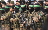 Illustrative: Hamas gunmen stand in formation ahead of a hostage release in Deir al-Balah, in the central Gaza Strip, February 8, 2025. (AP Photo/Abdel Kareem Hana)